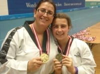 Mother and  daughter in the Tae Kwon Do medals