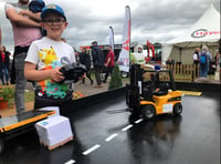 Mini forklifts on trade stand pull in young fans