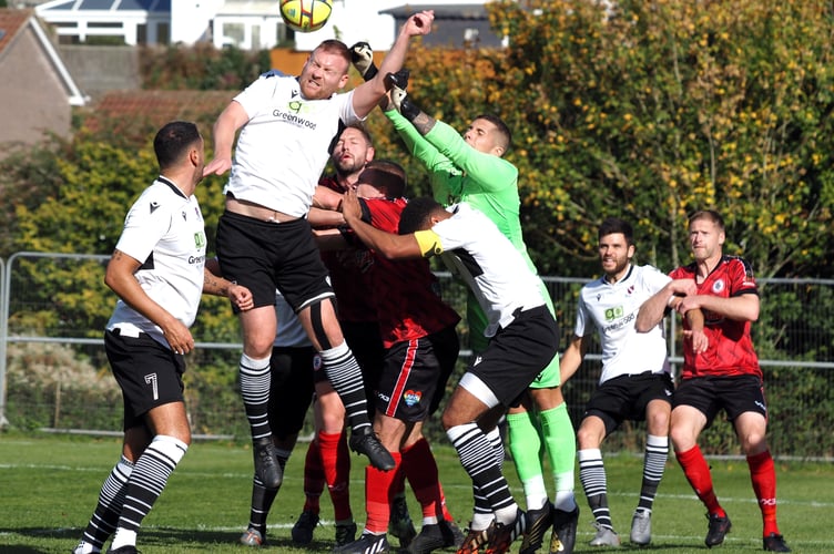 Teignmouth ‘keeper Zach Lee punches the ball clear one of few occasions that Bovey went forward.