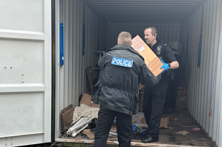 Police Officers assisting Trading Standards to seize the suspected illegal items