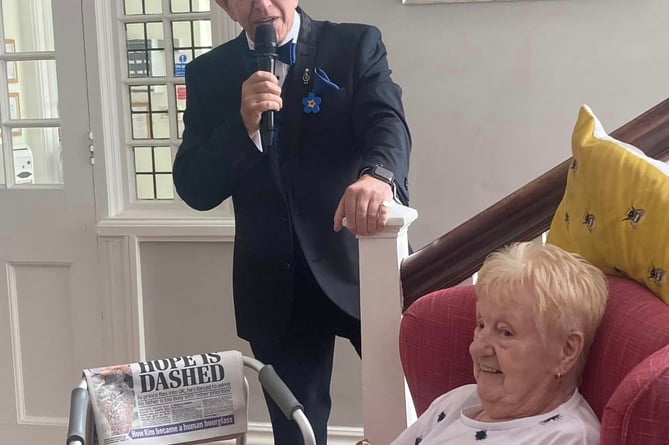 Peter MacDell serenades Mulberry House resident Pam Urquhart 