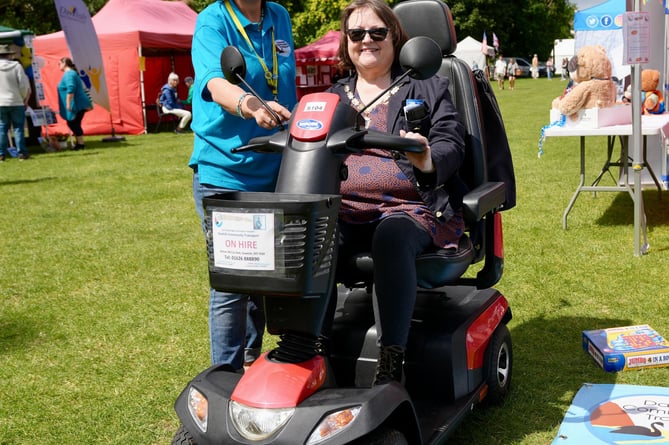 Dawlish Community Transport office manager Sally Preston (left) shows Mayor of Dawlish Cllr Lin Goodman-Bradbury a new mobility scooter 