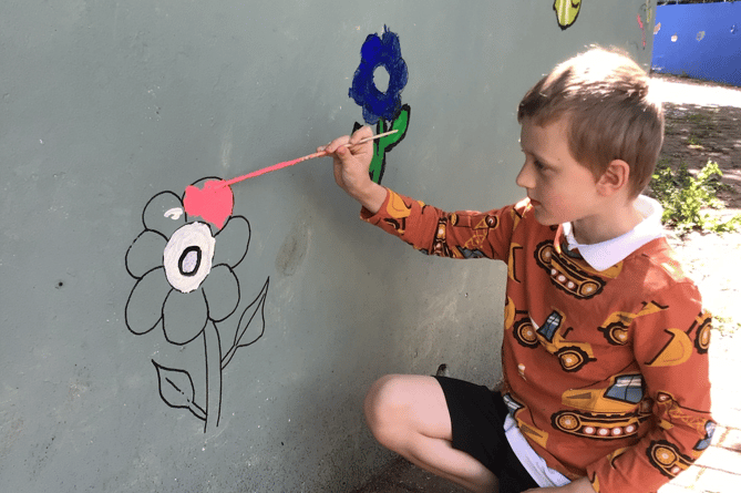 Year 3 pupil decorating the Meadow Centre 