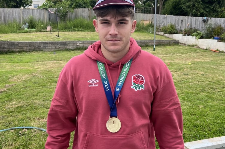 Ben Coen with his winners medal and cap