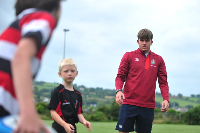 Ben Coen, of England's  Under-20 World Rugby Championship winning team, with young members of Teignmouth Rugby Club