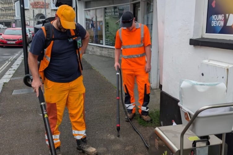 Task force clearing gum from pavements in Newton Abbot.