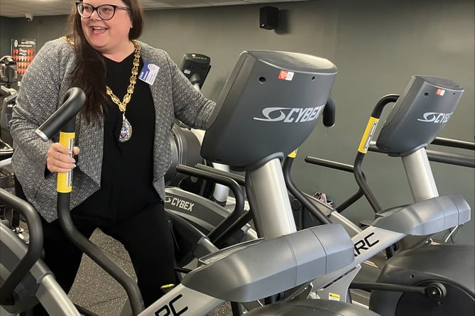 Teignbridge Council chairman Cllr Rosie Dawson tries out new accessible gym equipment.