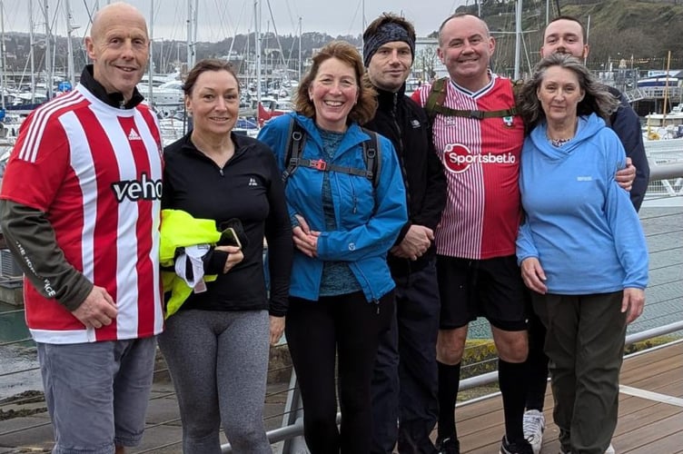 RNLI charity walkers reach their destination at Torquay harbour. 